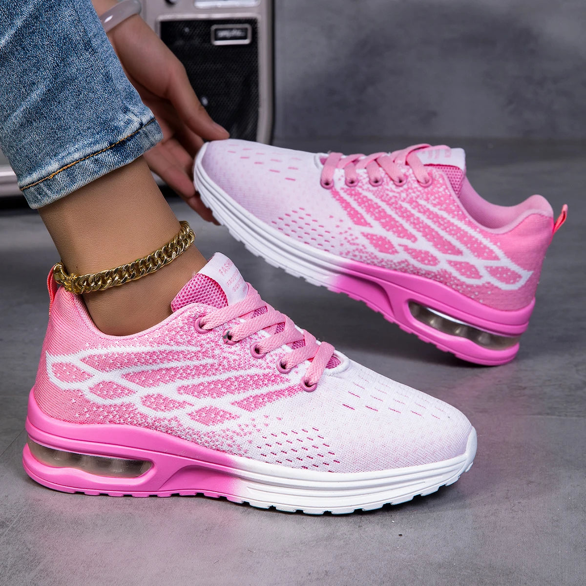 Pink women's lace-up sneakers with air mesh upper and rubber sole, cushioned midsole for casual walking.